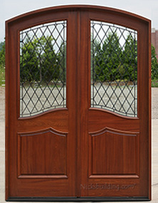 Arched double door with wrought iron glass